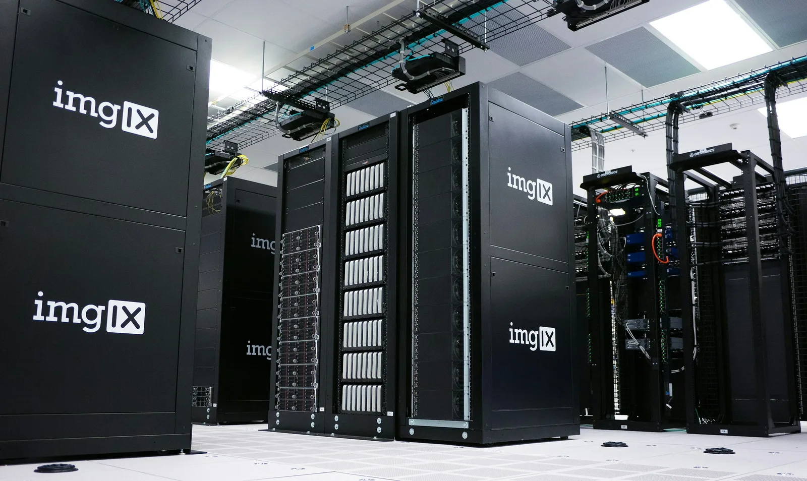 Rows of illuminated server racks in a working data center